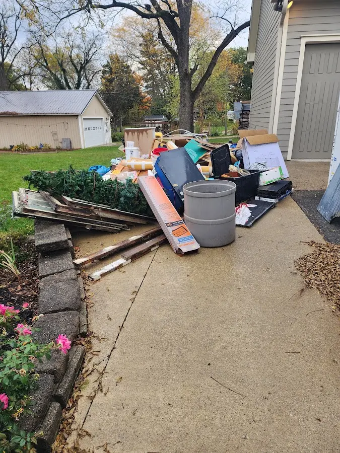 Dumpster being loaded with debris for Estate Cleanout Dumpster Rental in Mooresville